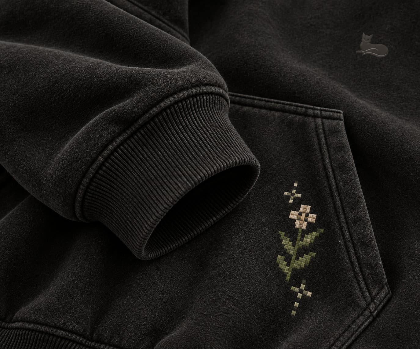 Close-up of cross-stitch flower embroidery on the pocket