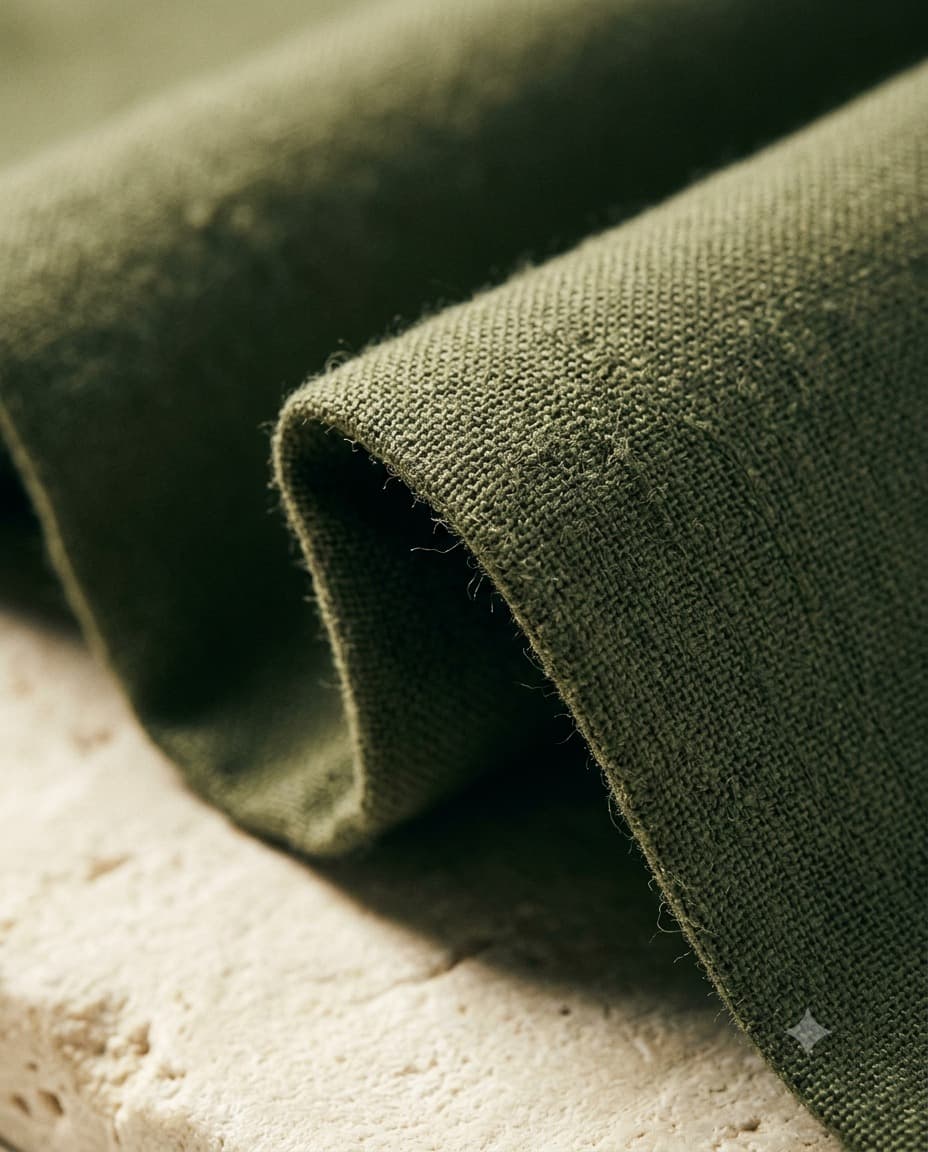 A fold of olive linen showing its open weave